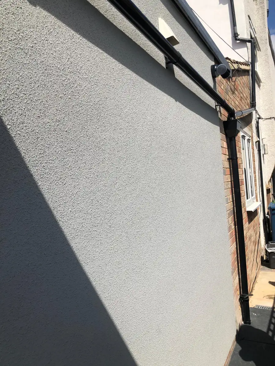 Wall after external wall insulation and render by Kev Construct, North London